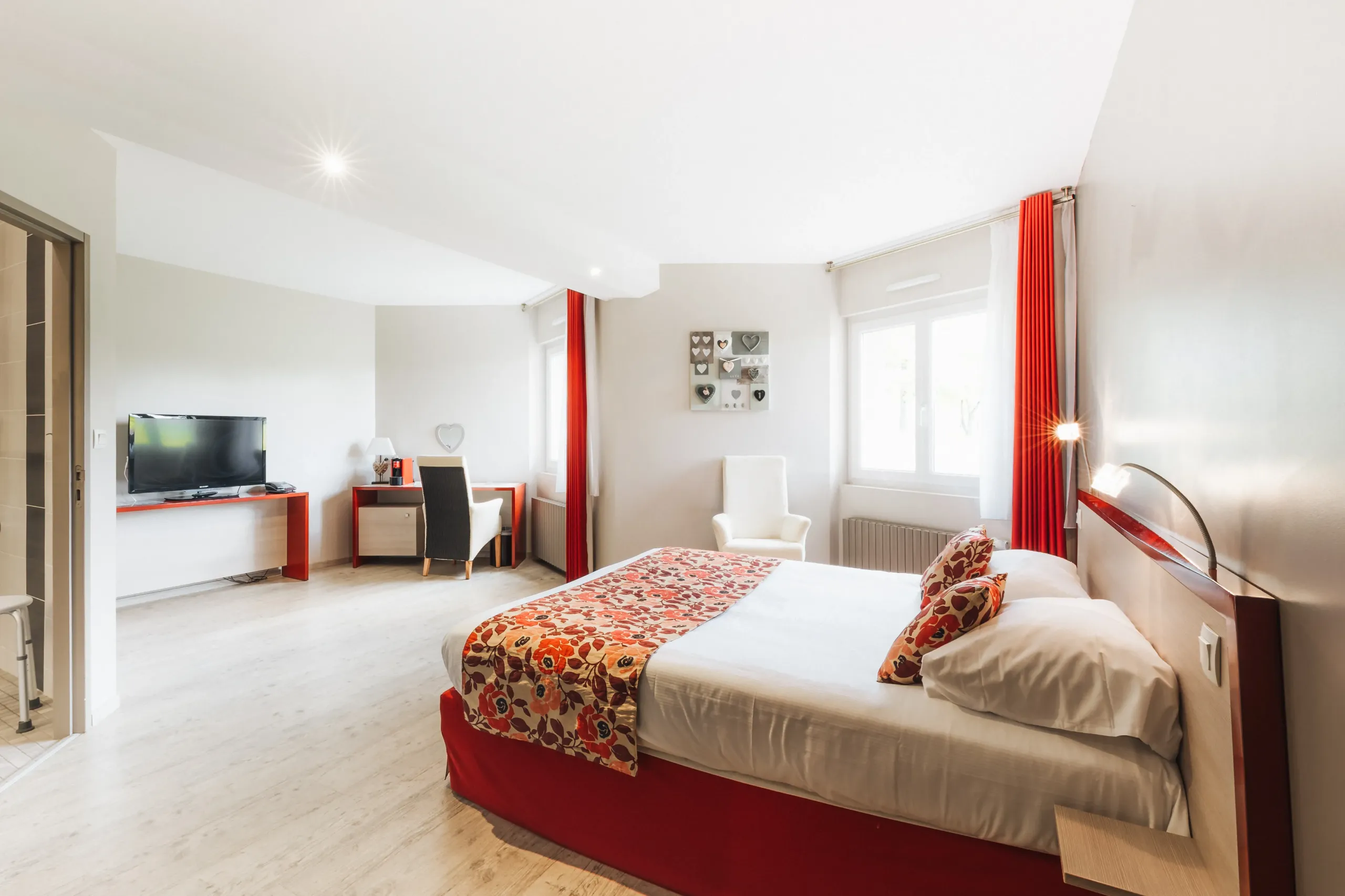 Chambre d’hôtel lumineuse avec lit double et bureau